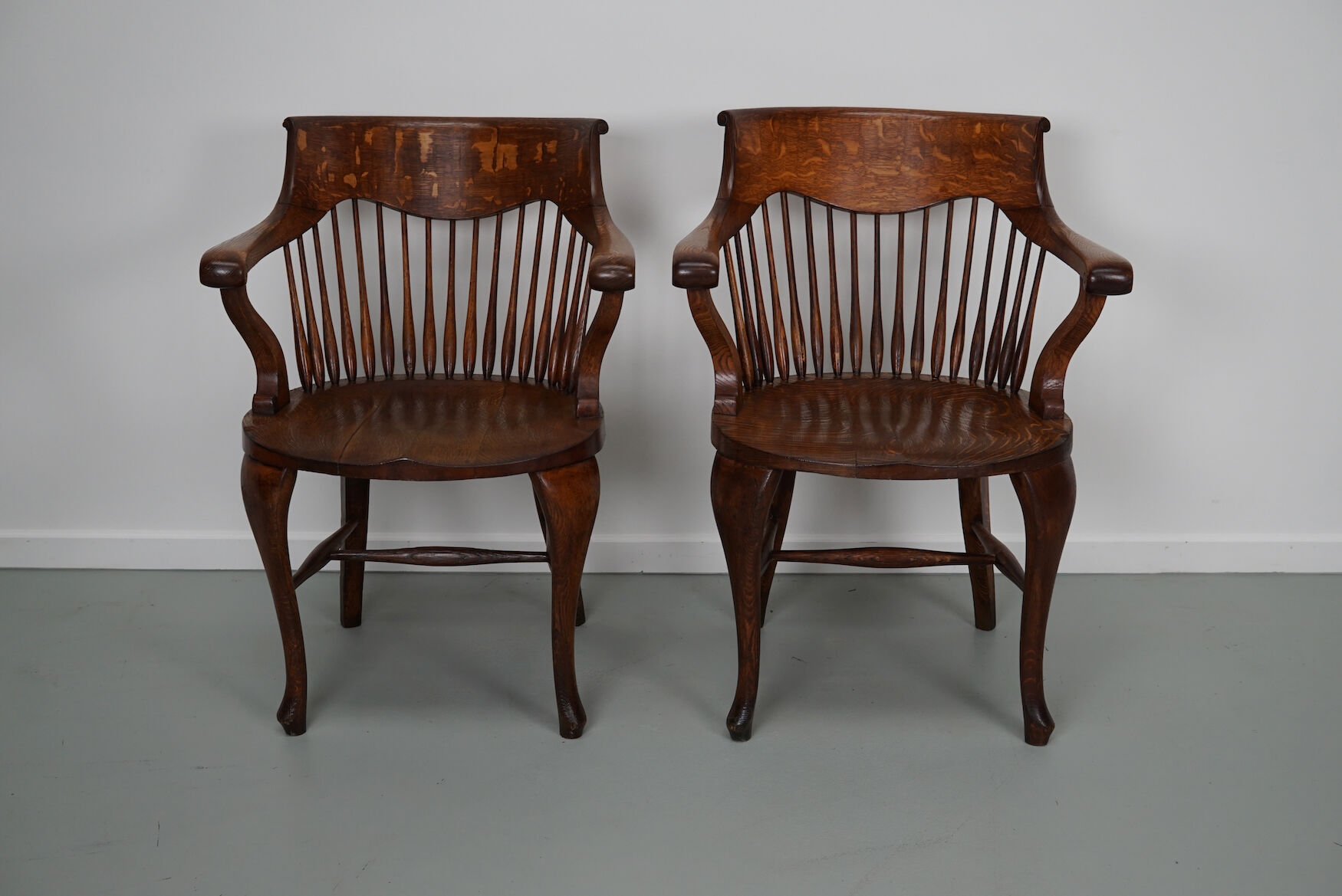 Pair of English Edwardian Oak Spindle Back Captains Office Desk Chairs