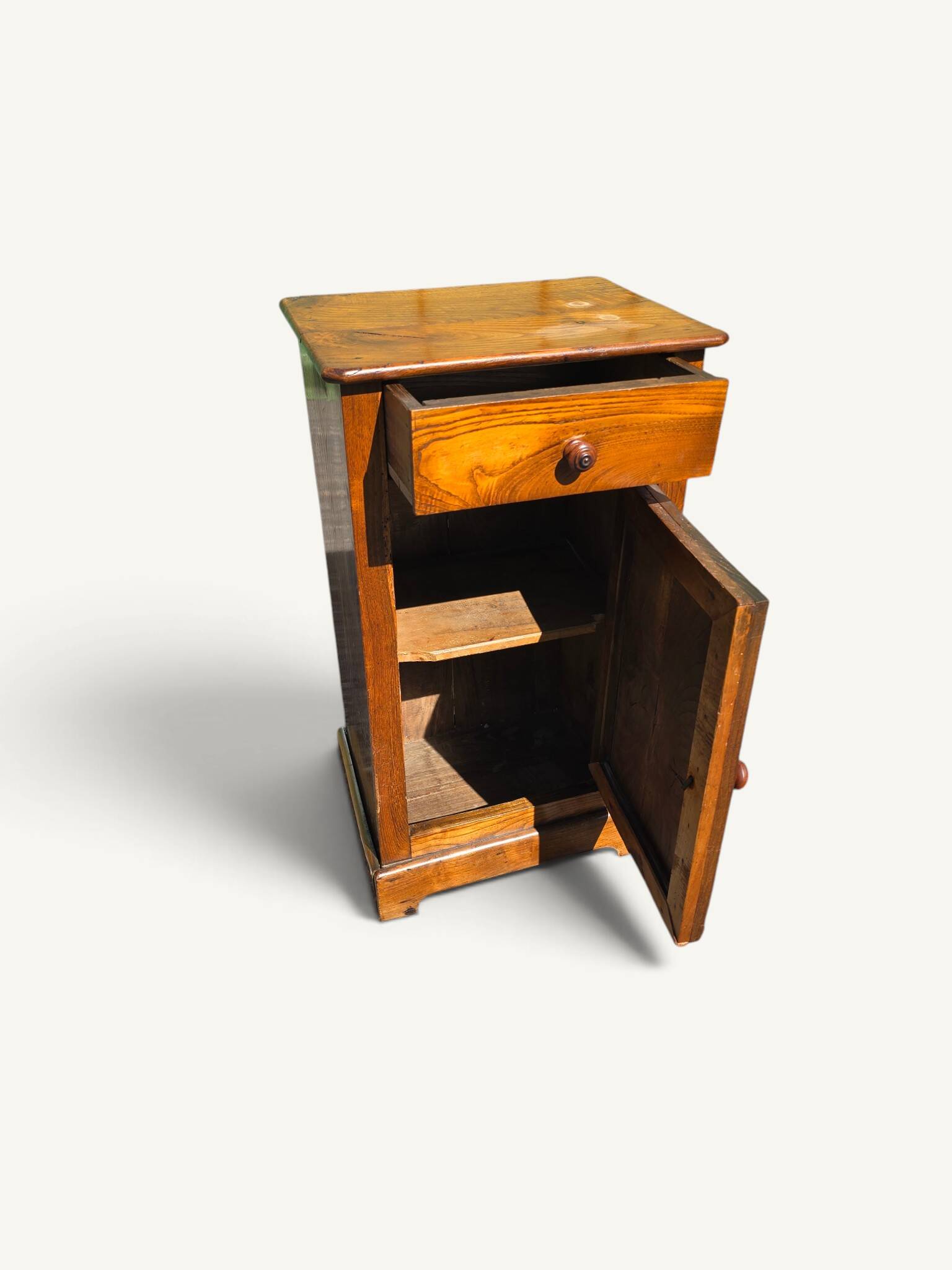 Small rustic antique bedside table made of solid wood.