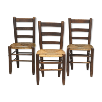 3 wooden and straw chairs