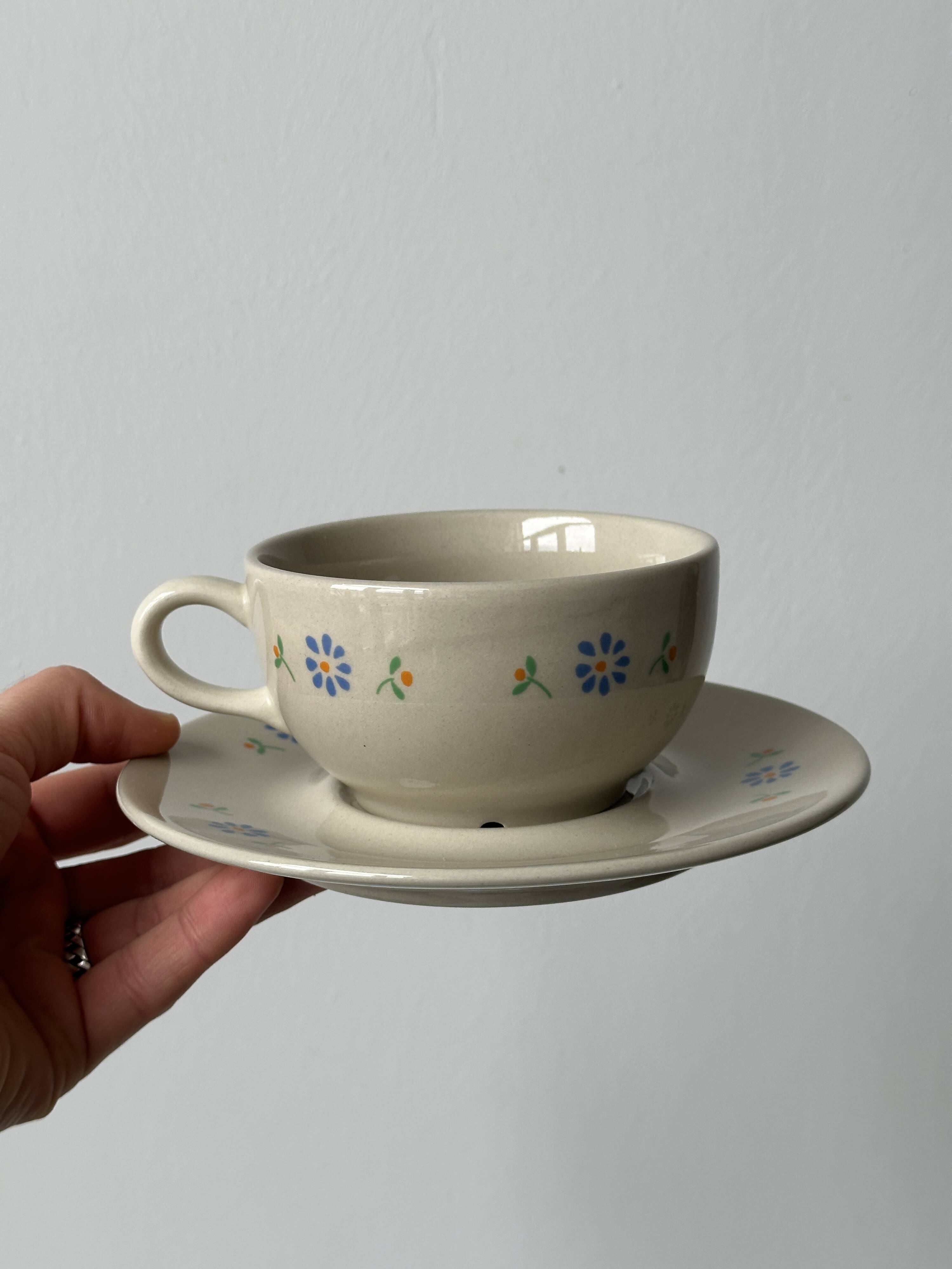 Ceramic cups and saucers with flower decoration