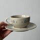 Ceramic cups and saucers with flower decoration