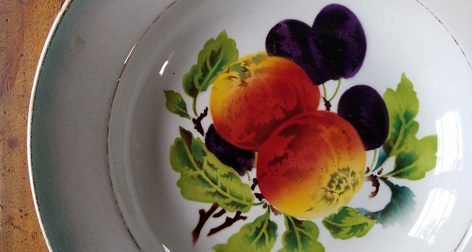 Round dish in Earthenware St Amand decorated with fruit apples and plums