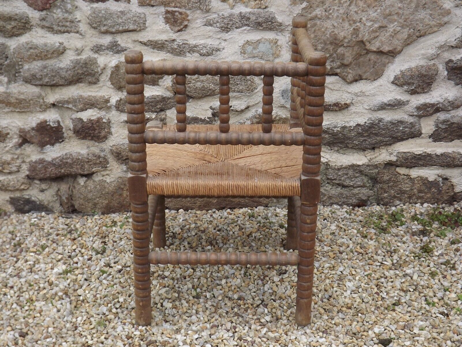 French antique turned wooden bobbin chair with rush seat