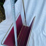 Vintage magazine rack in red skai with gold metal frame and plastic handle