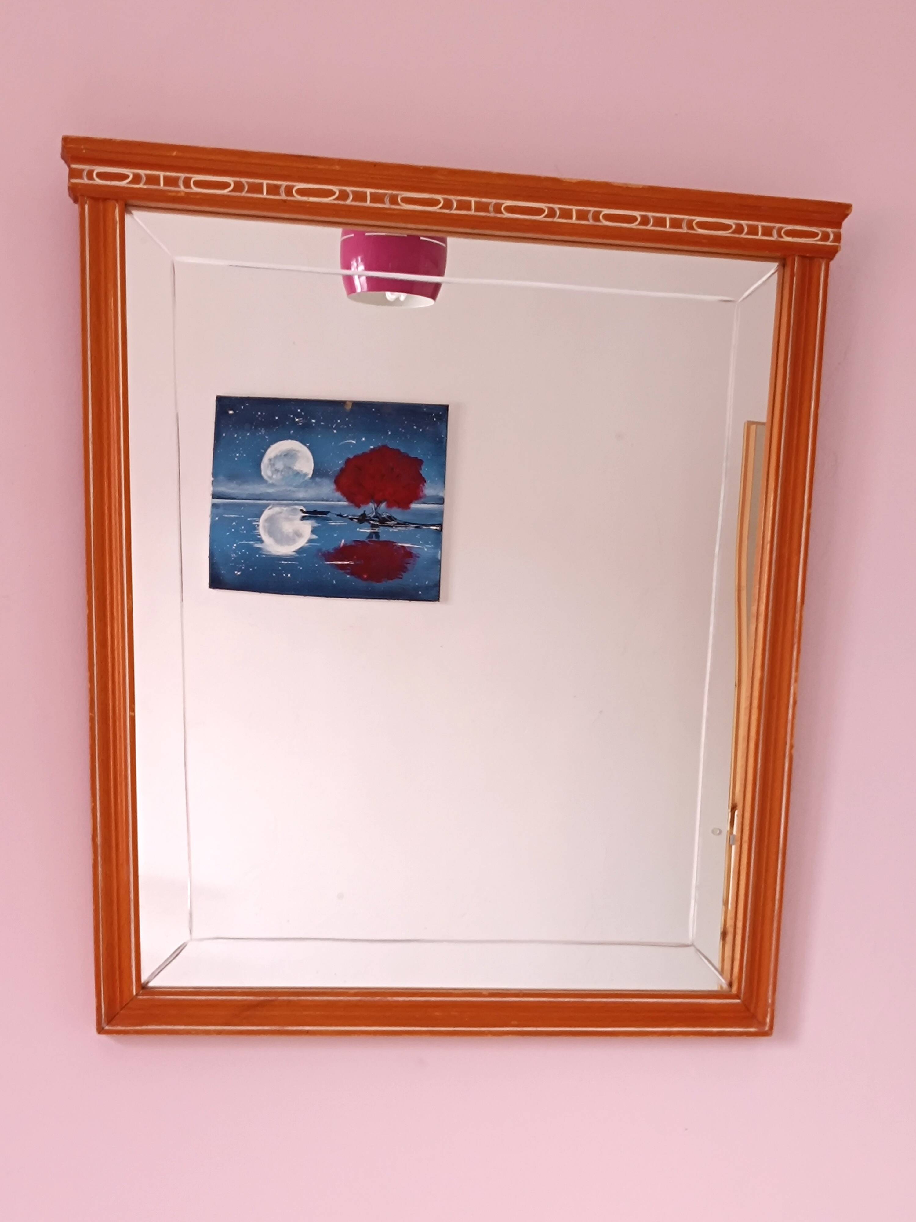 Beveled glass wall mirror in solid wood frame