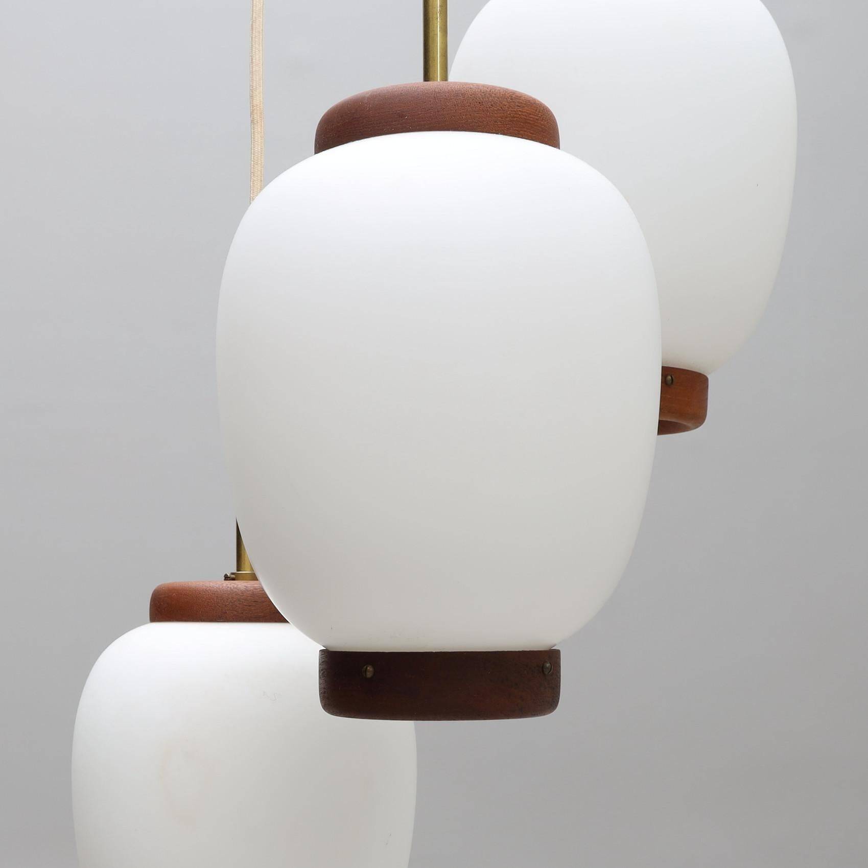 Bent Karlby "China" pendant lights, 3 lights, teak and glass, Lyfa, Denmark, 1960.