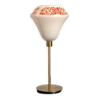 Table lamp with a vintage white glass globe with orange flowers