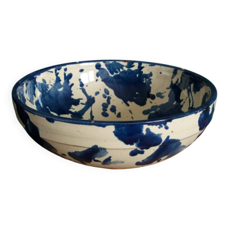 Empty pocket bowl in terracotta, glazed with "ink spots" design.