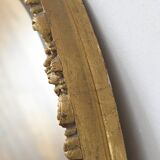 Beveled oval mirror and gilded wood frame