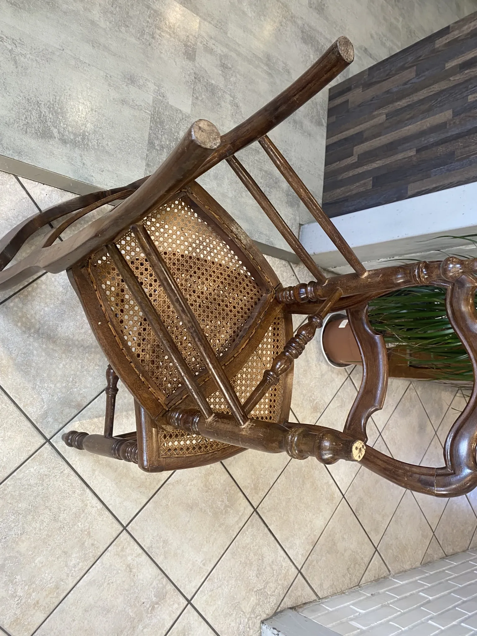 Pair of antique caned and wooden chairs from the 1900s.