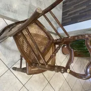 Pair of antique caned and wooden chairs from the 1900s.