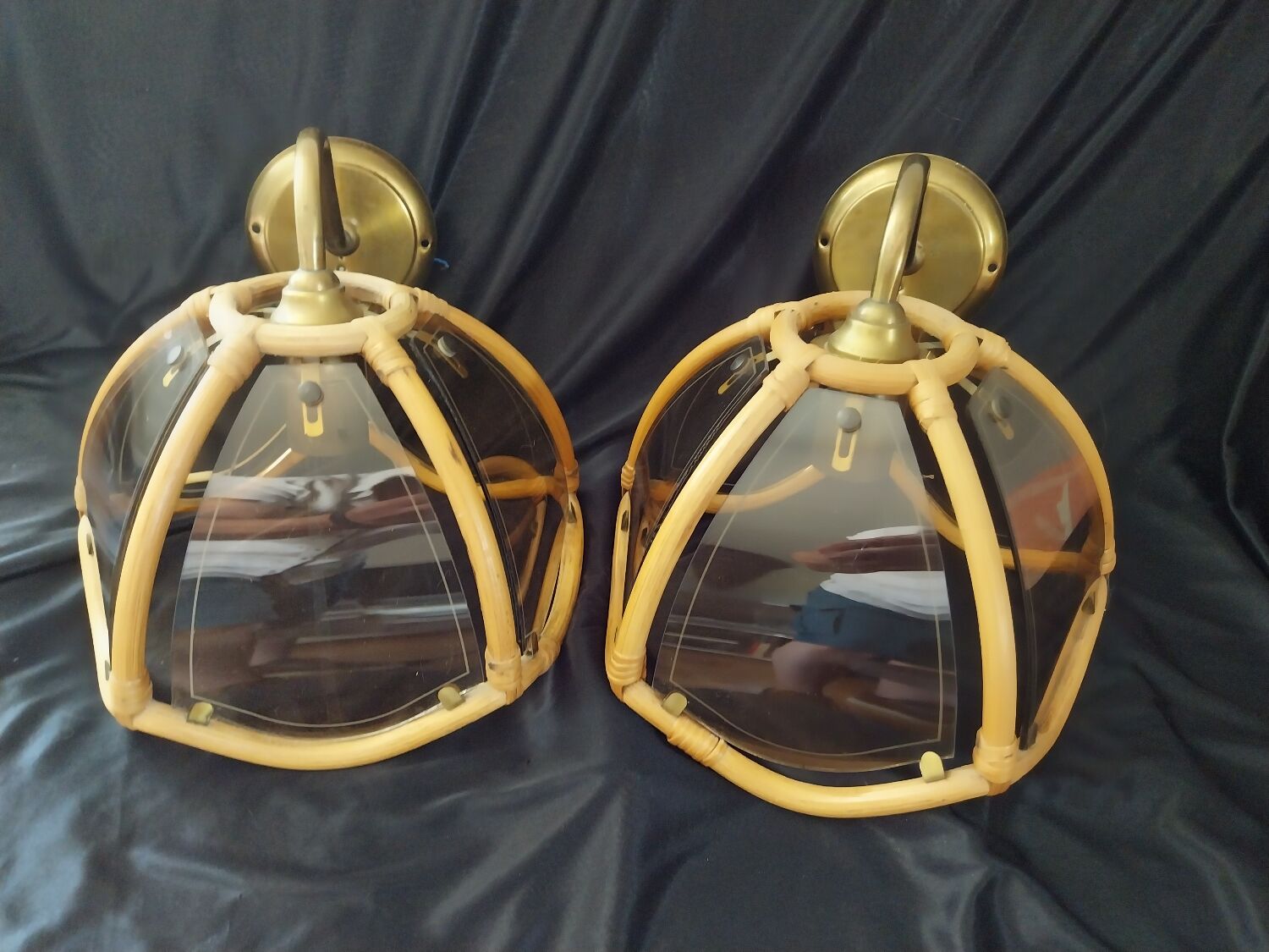 Wall sconces in rattan and smoked glass