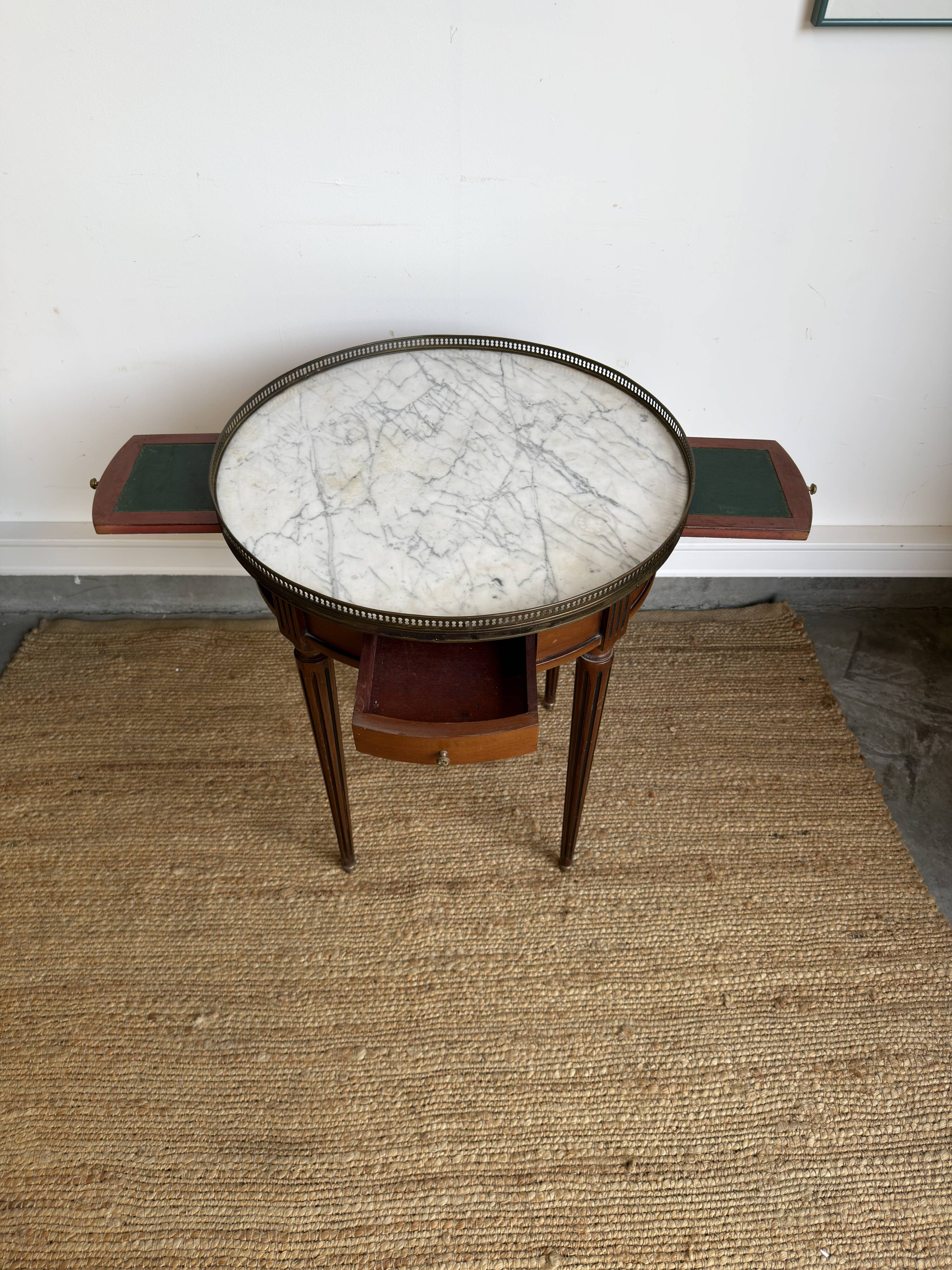 Louis XVI style bouillotte table in mahogany, white marble, and brass.