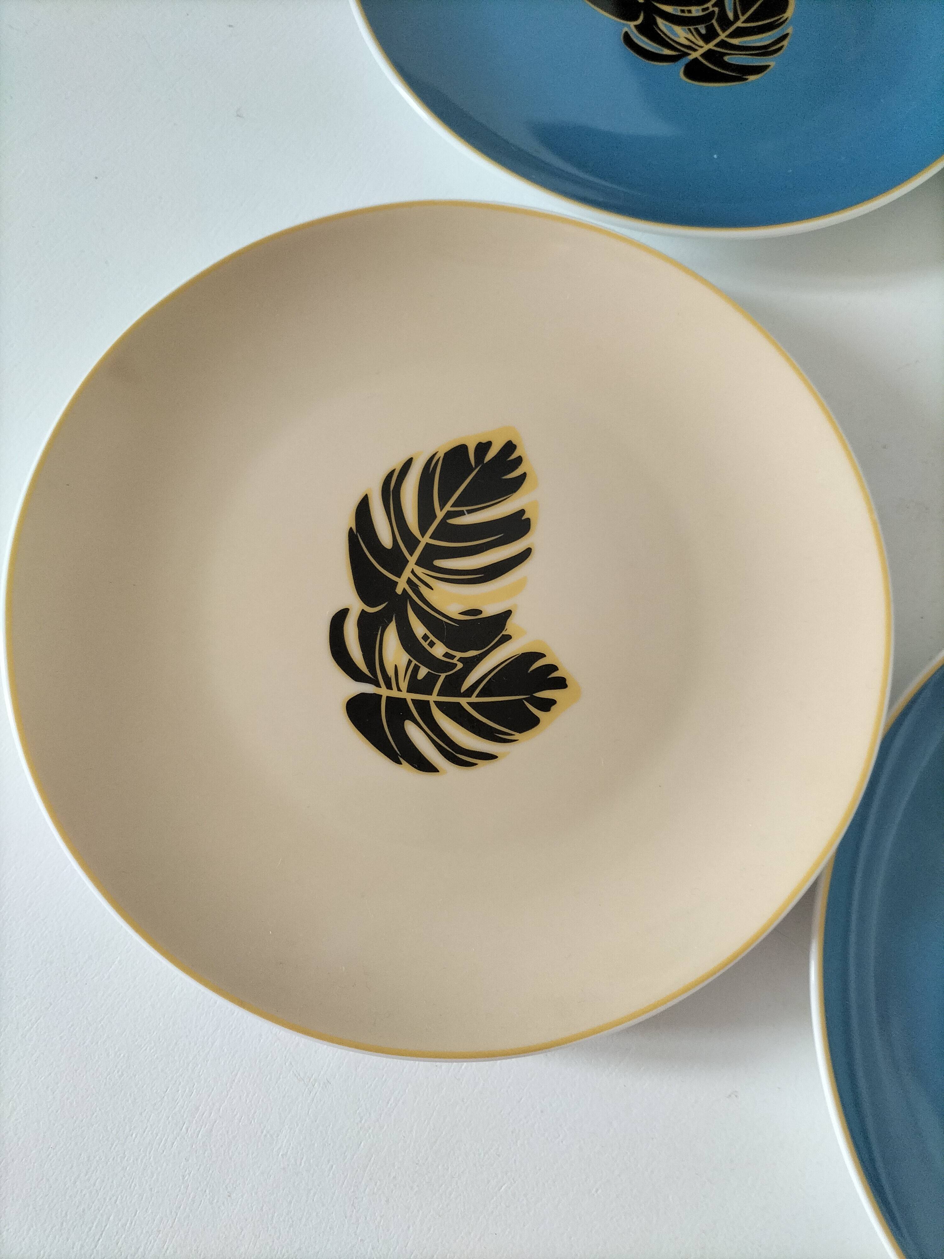 Set of 7 porcelain plates, gold foliage & jungle