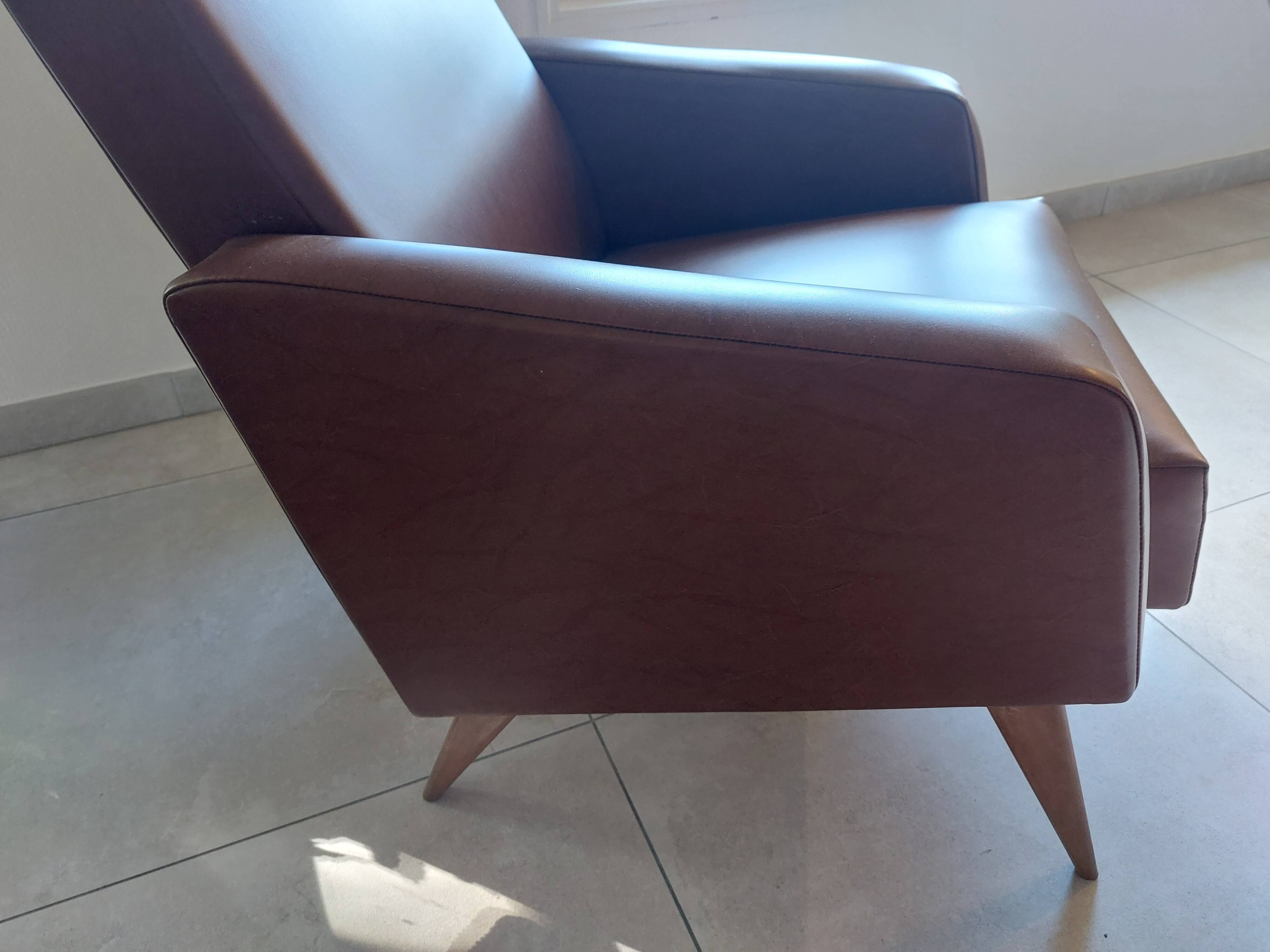 a pair of comfortable vintage armchairs with splayed legs