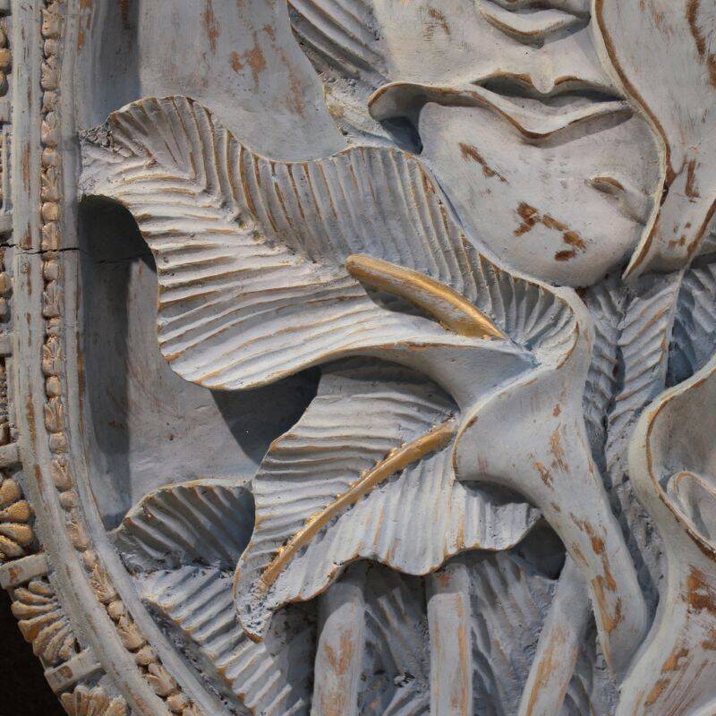 Bas-relief sculpture, stylized face with flowers, 20th century