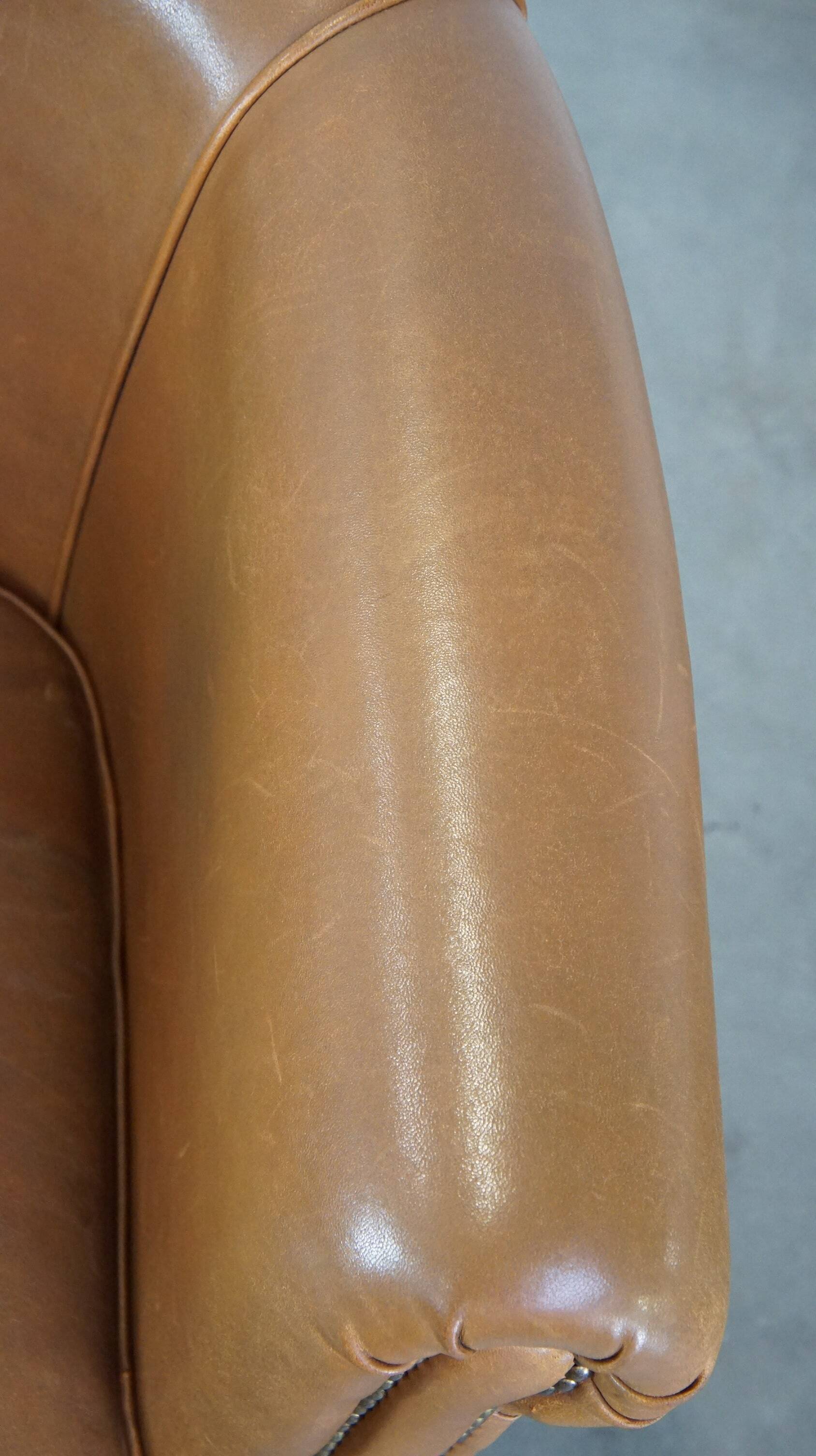 Sheep leather club chair in neutral cognac colour and in good condition