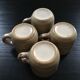 Set of 4 beige stoneware mugs.