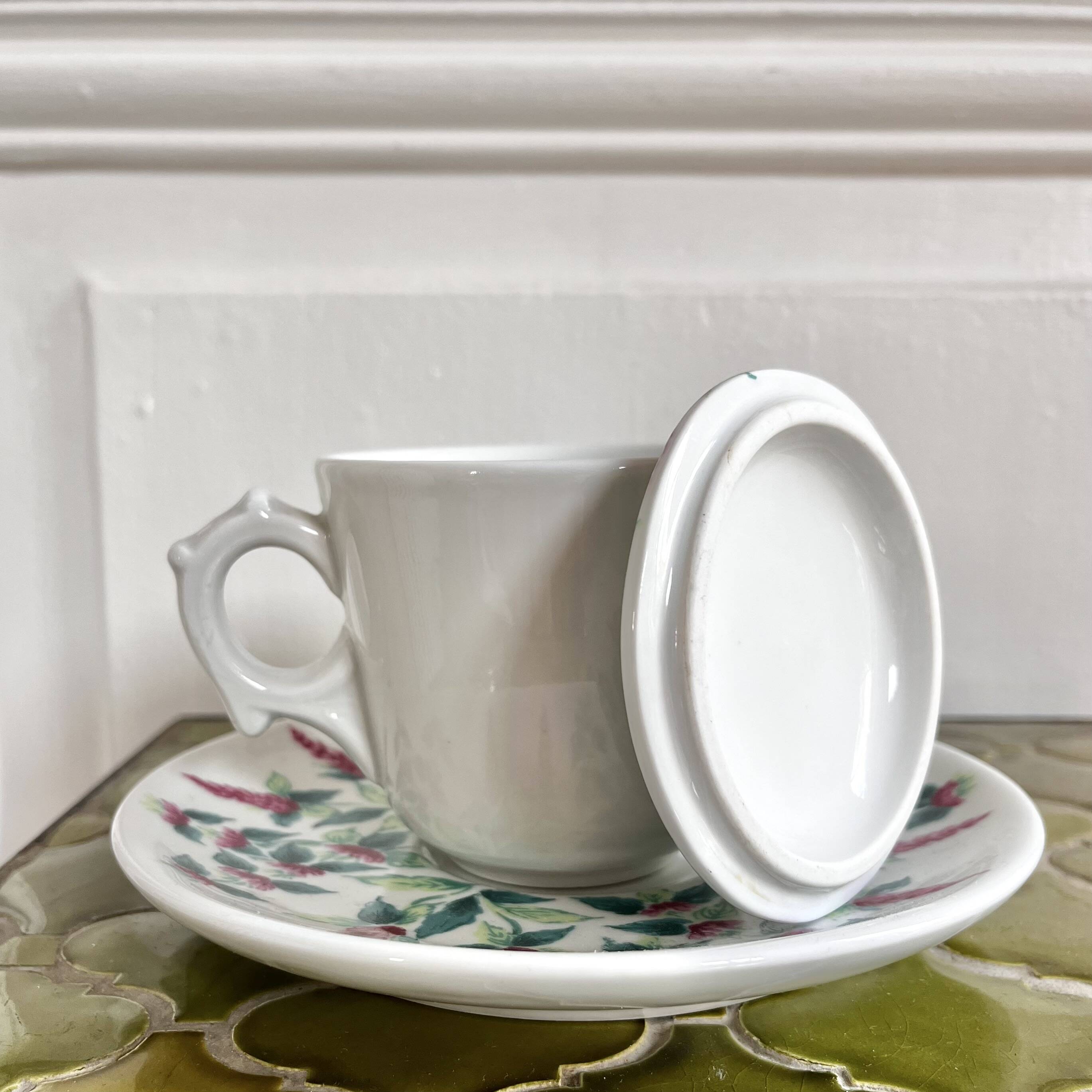 Antique herbal tea cup with mint infusion