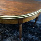 A Louis XVI period mahogany half-moon table forming a console/games table