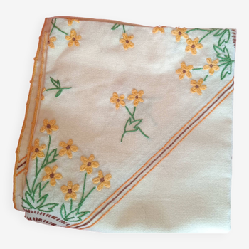 Hand-embroidered yellow square tablecloth.