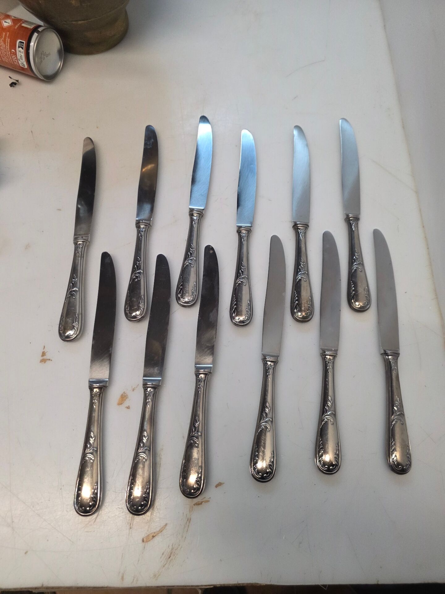 12 silver-plated metal knives from the mid-20th century