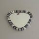 Small wall mirror, round triangle in black and white ceramic, 1950s, Germany.