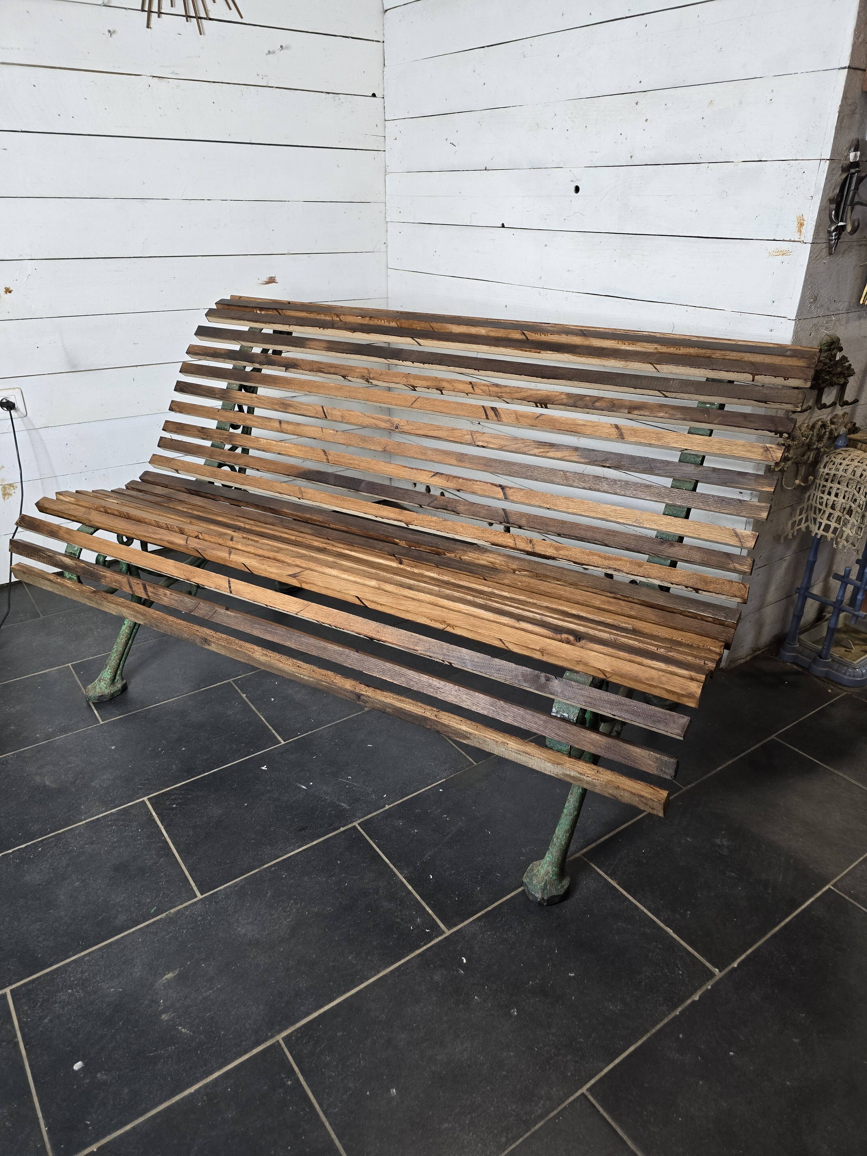 Old cast iron garden bench with oak slats