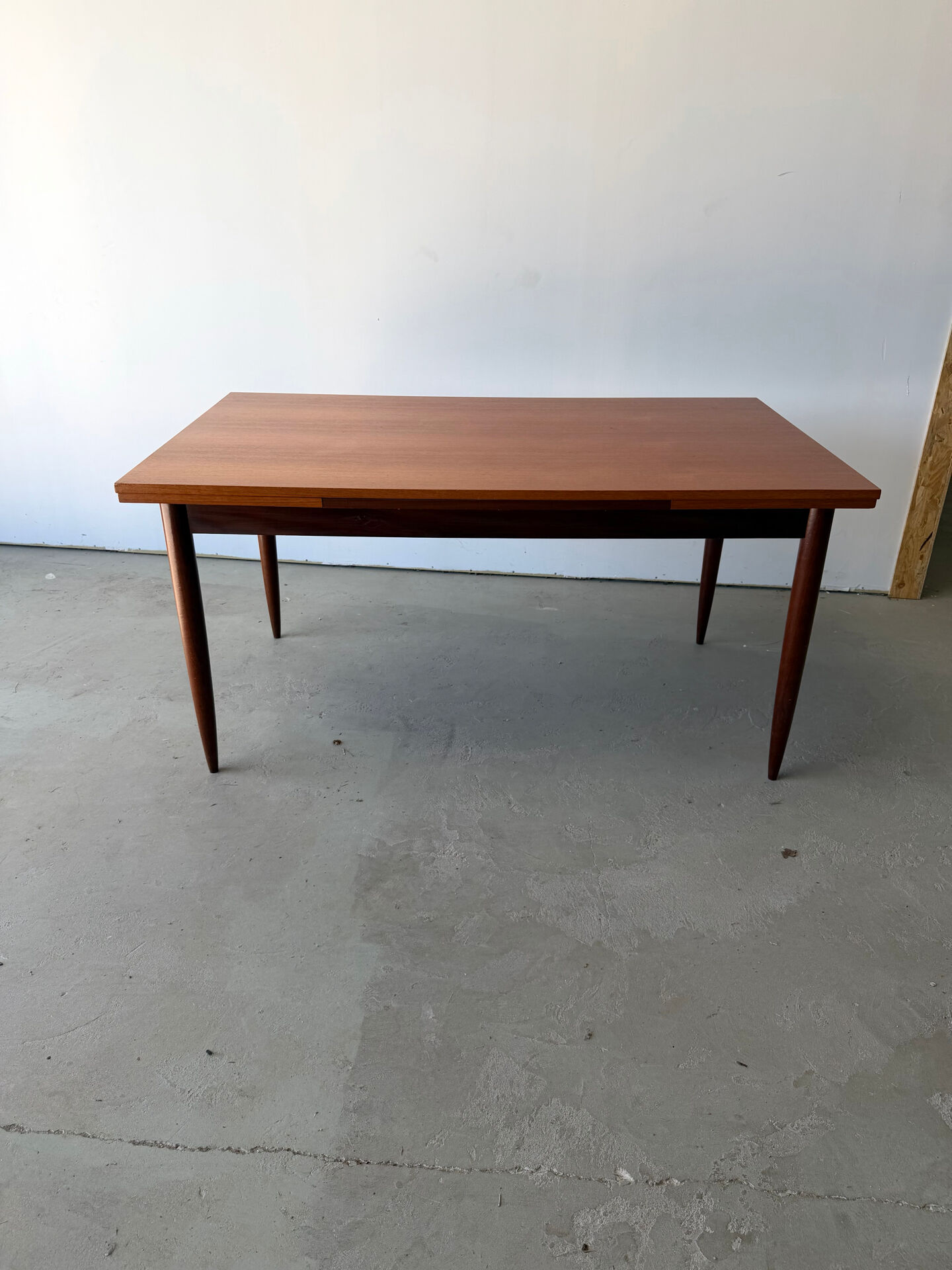 Rectangular extendable dining table with Scandinavian design in teak.