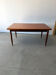 Rectangular extendable dining table with Scandinavian design in teak.