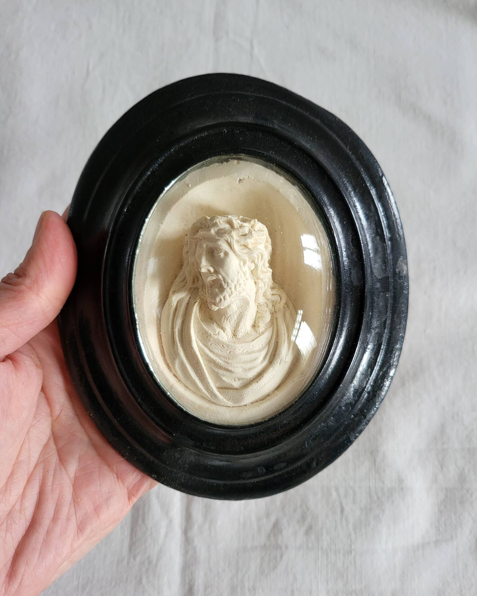 Ancient religious medallion, Jesus Christ in plaster with a blackened wooden frame.