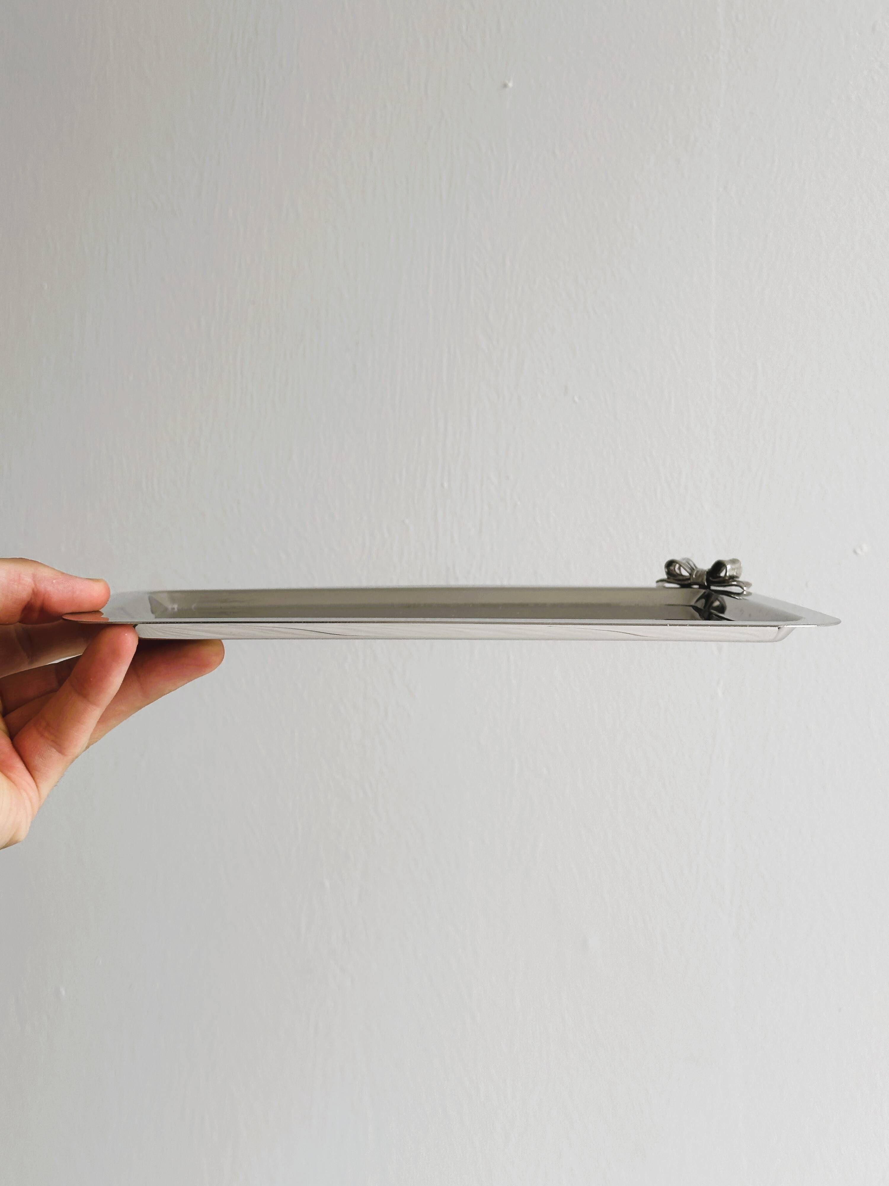 Small vintage metal tray with decorative knot