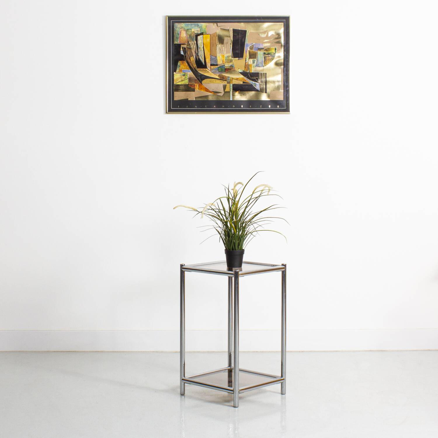 Bolster or end table in chrome steel with smoked window.