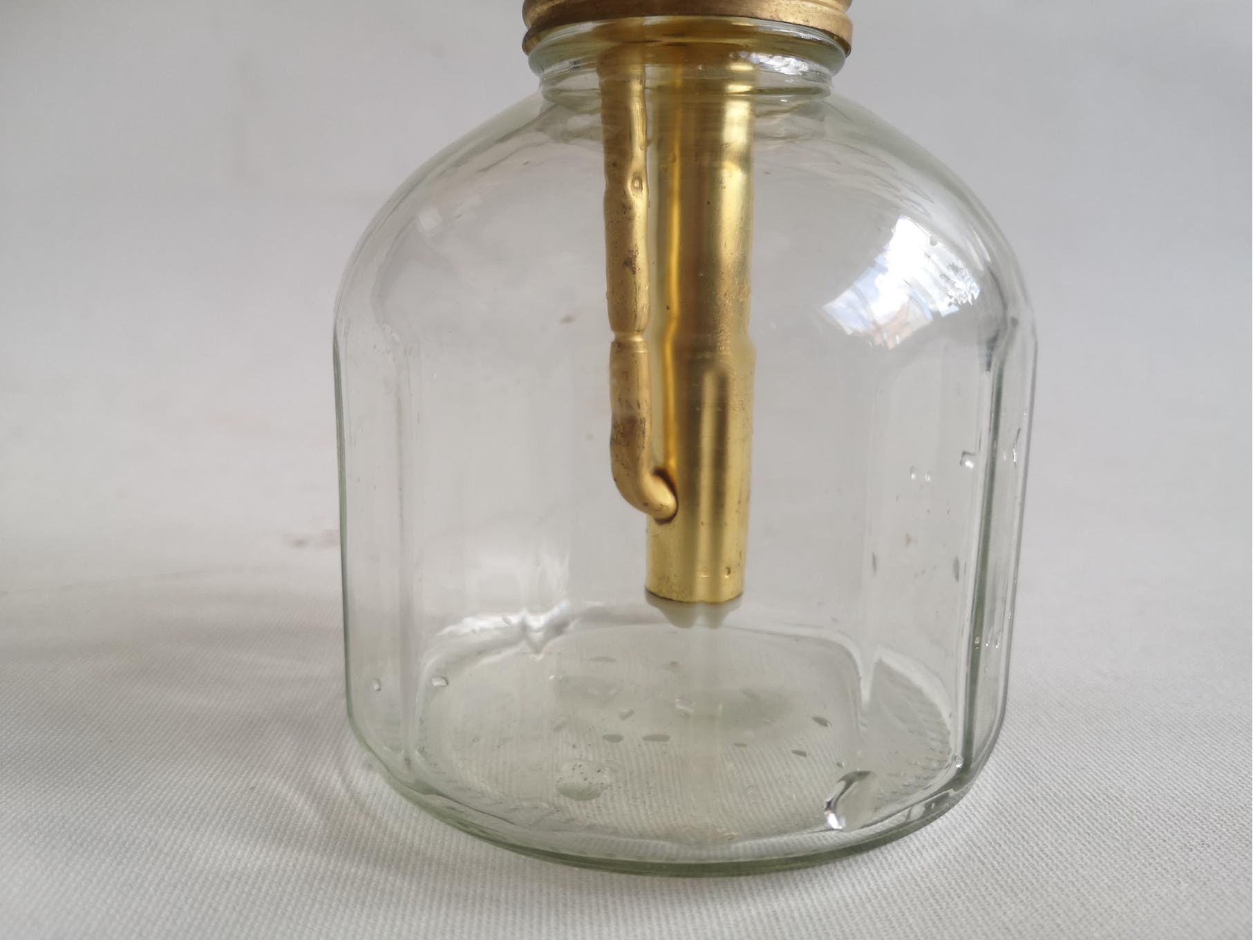 Transparent glass spray and gold metal