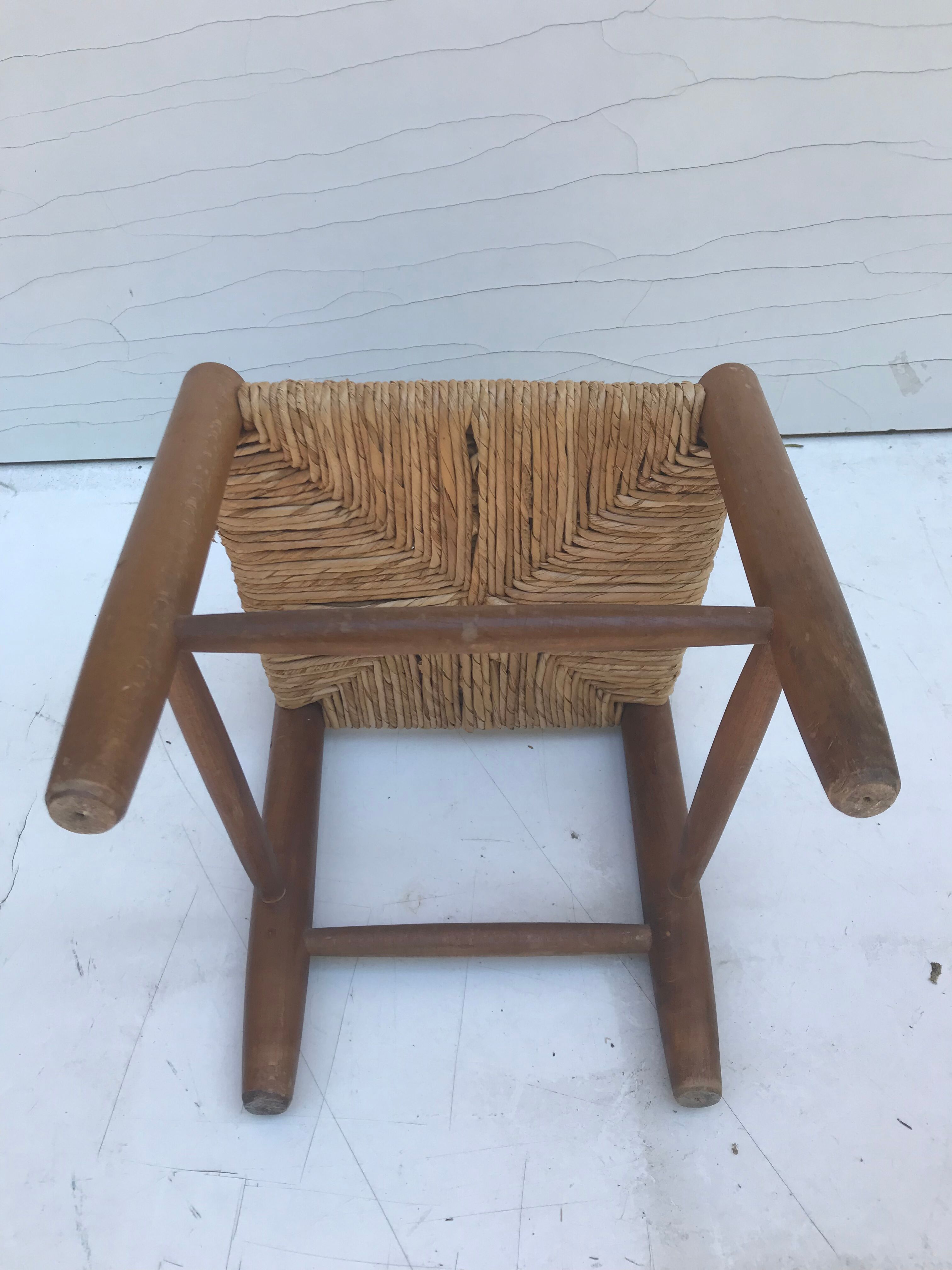 Old wooden children's chair with vintage braided seat