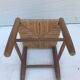 Old wooden children's chair with vintage braided seat