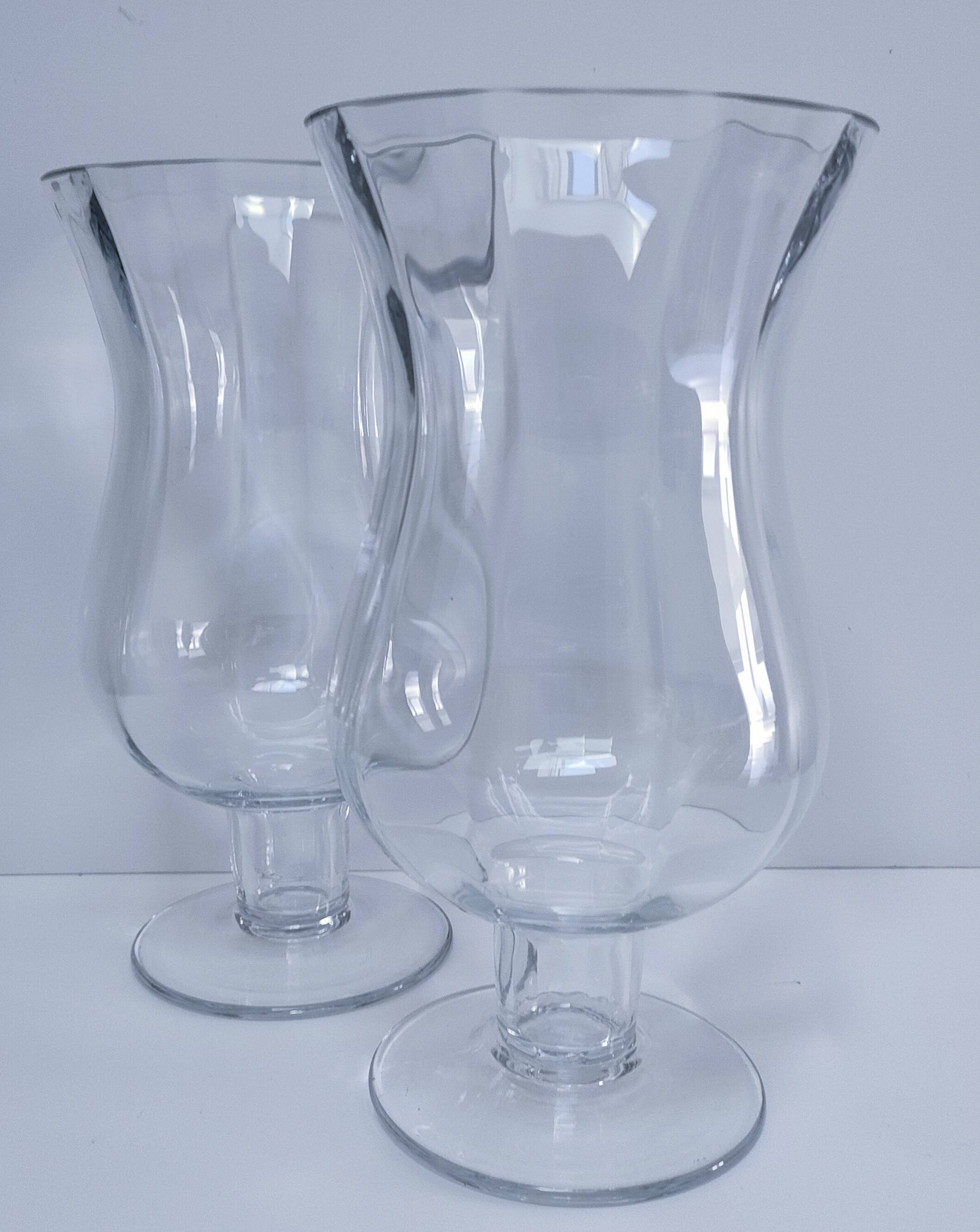 Pair of tall clear glass candlesticks from the early 20th century