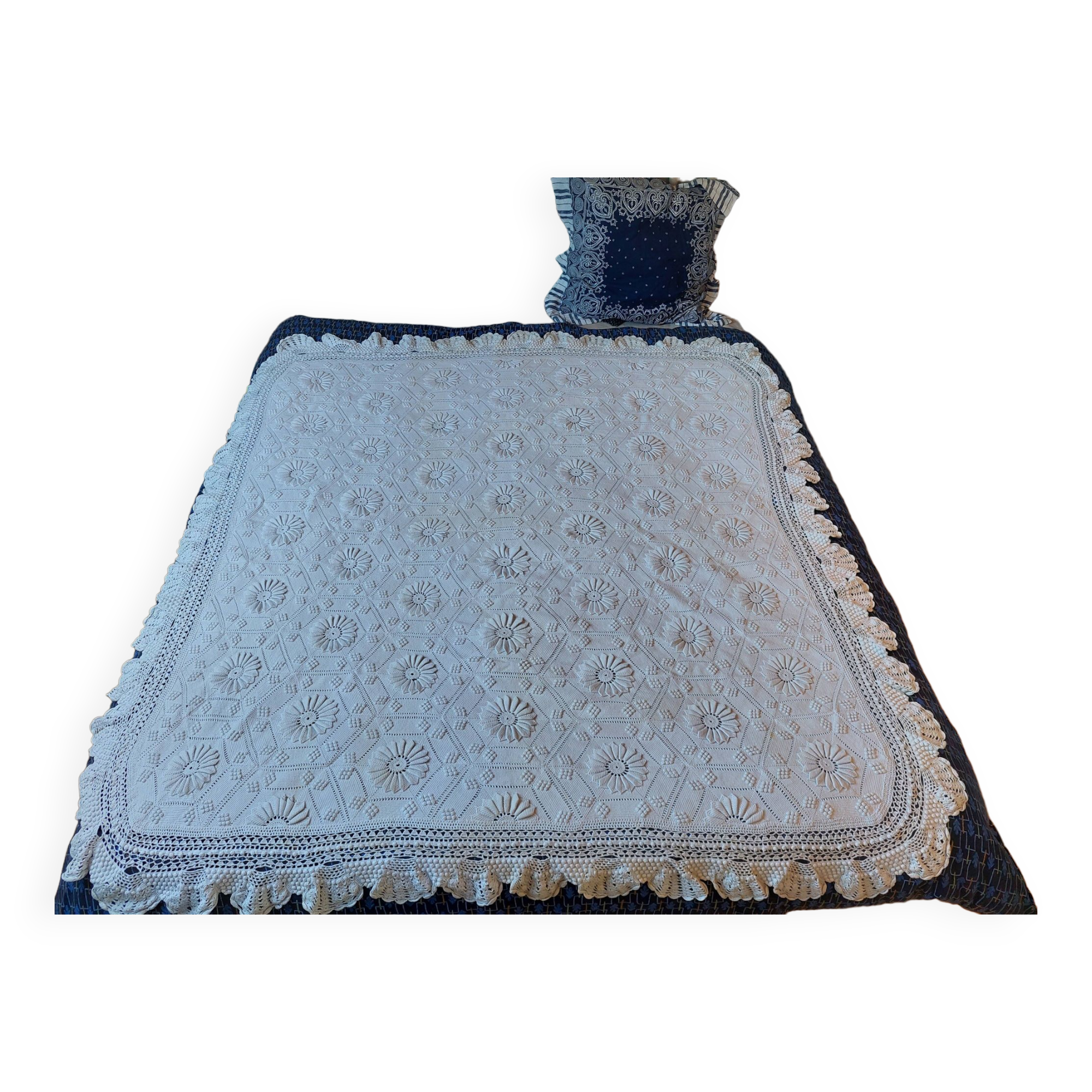 White bed throw with relief embroidery and floral patterns