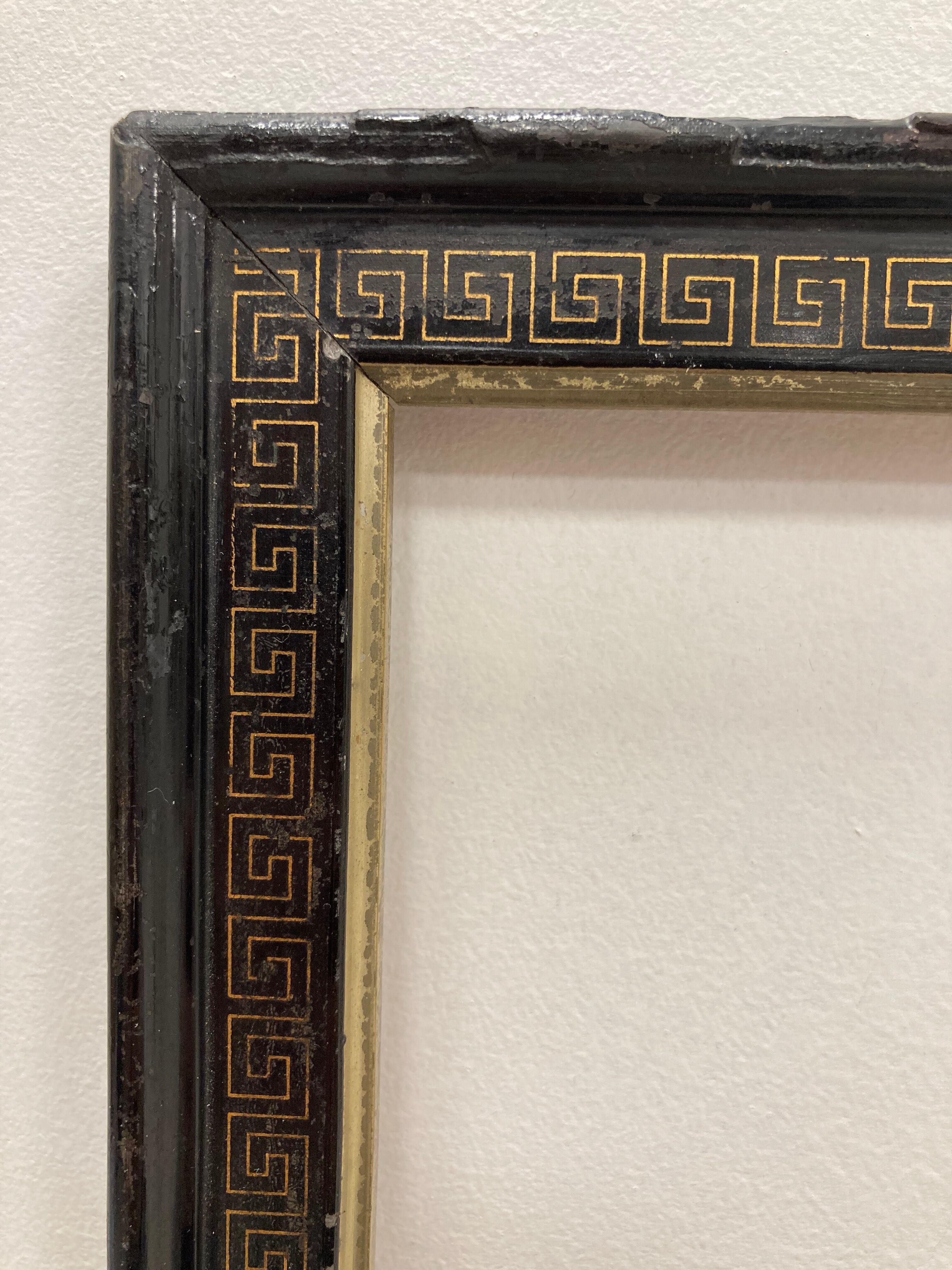 Black and gold frame decorated with Greek frieze decoration