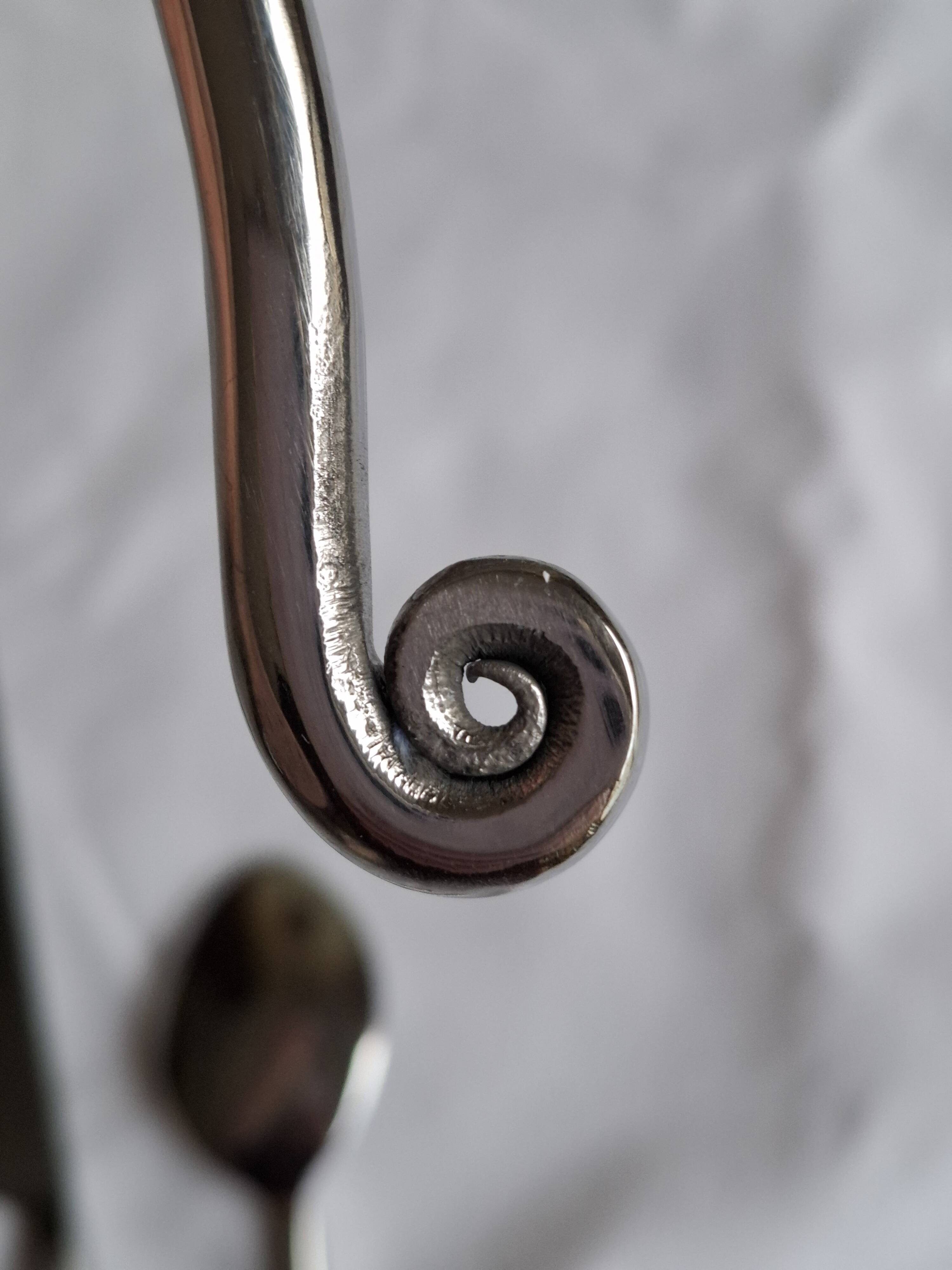 Twisted metal cutlery with a fancy spiral design.