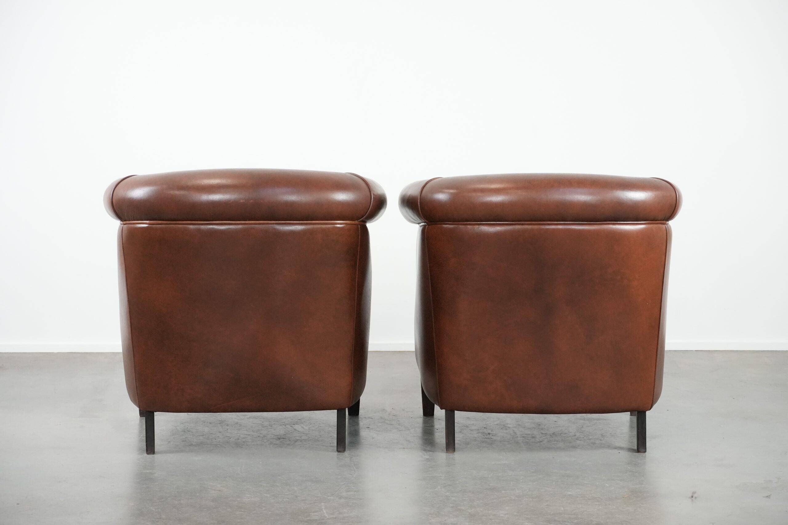 Unique set of two cognac-coloured cow leather club armchairs