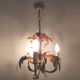 Golden metal chandelier palm leaves