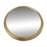 Round mirror in gold metal