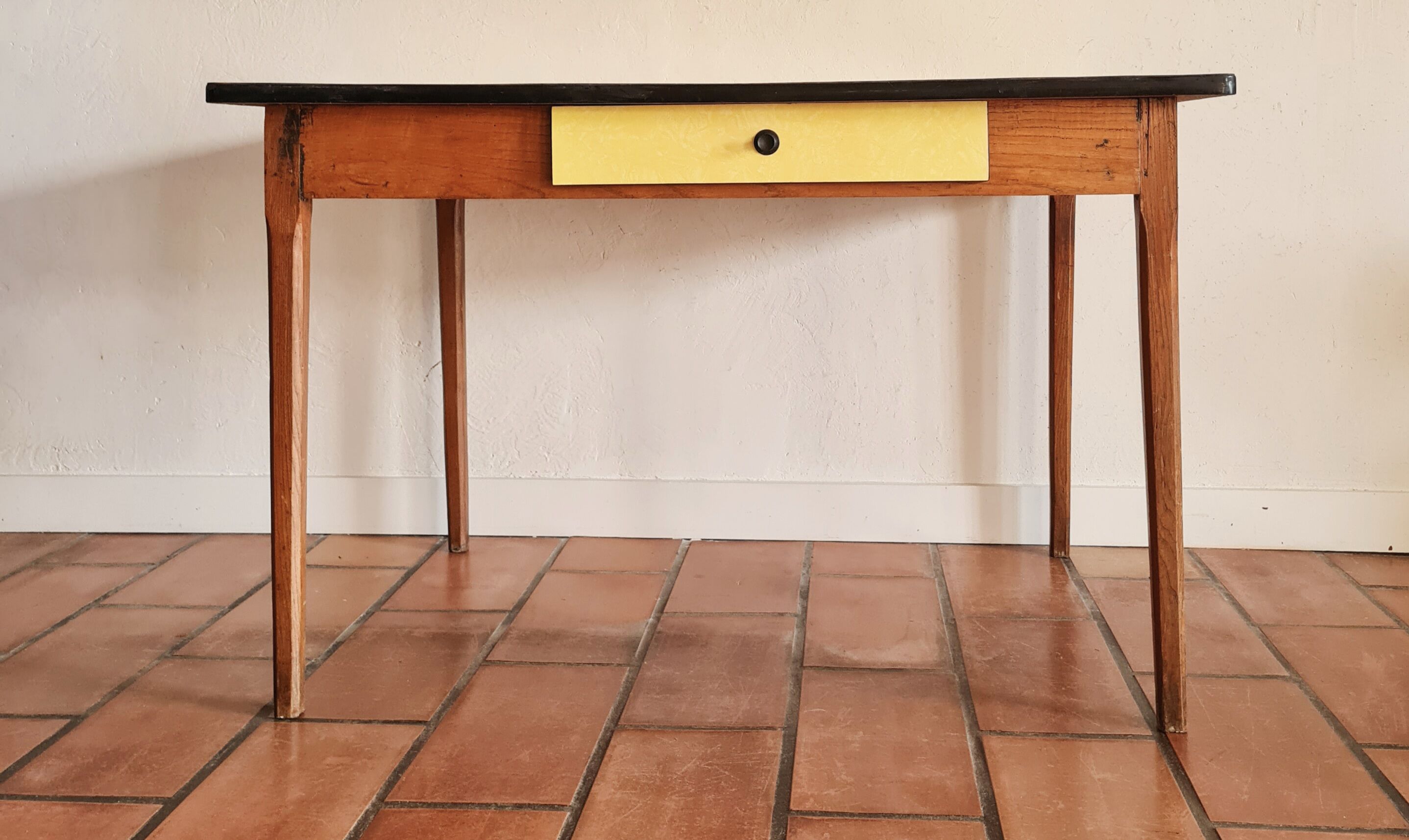 Old wooden farmhouse table and yellow formica top