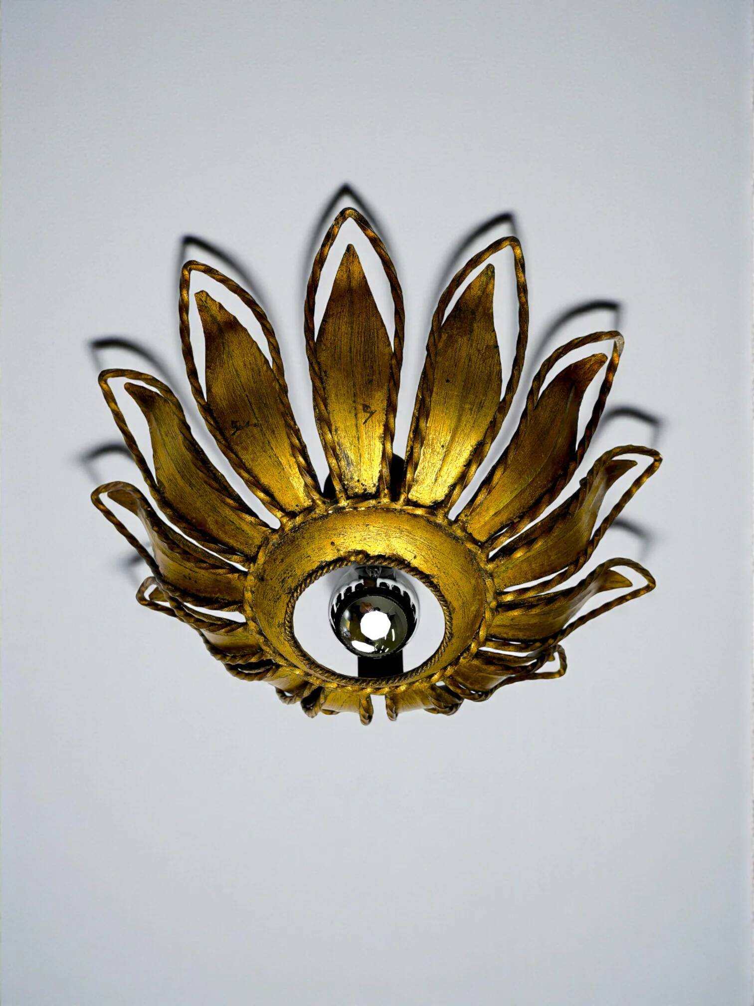 Spanish sunburst ceiling light fixture or sconce in gilt iron, circa 1960