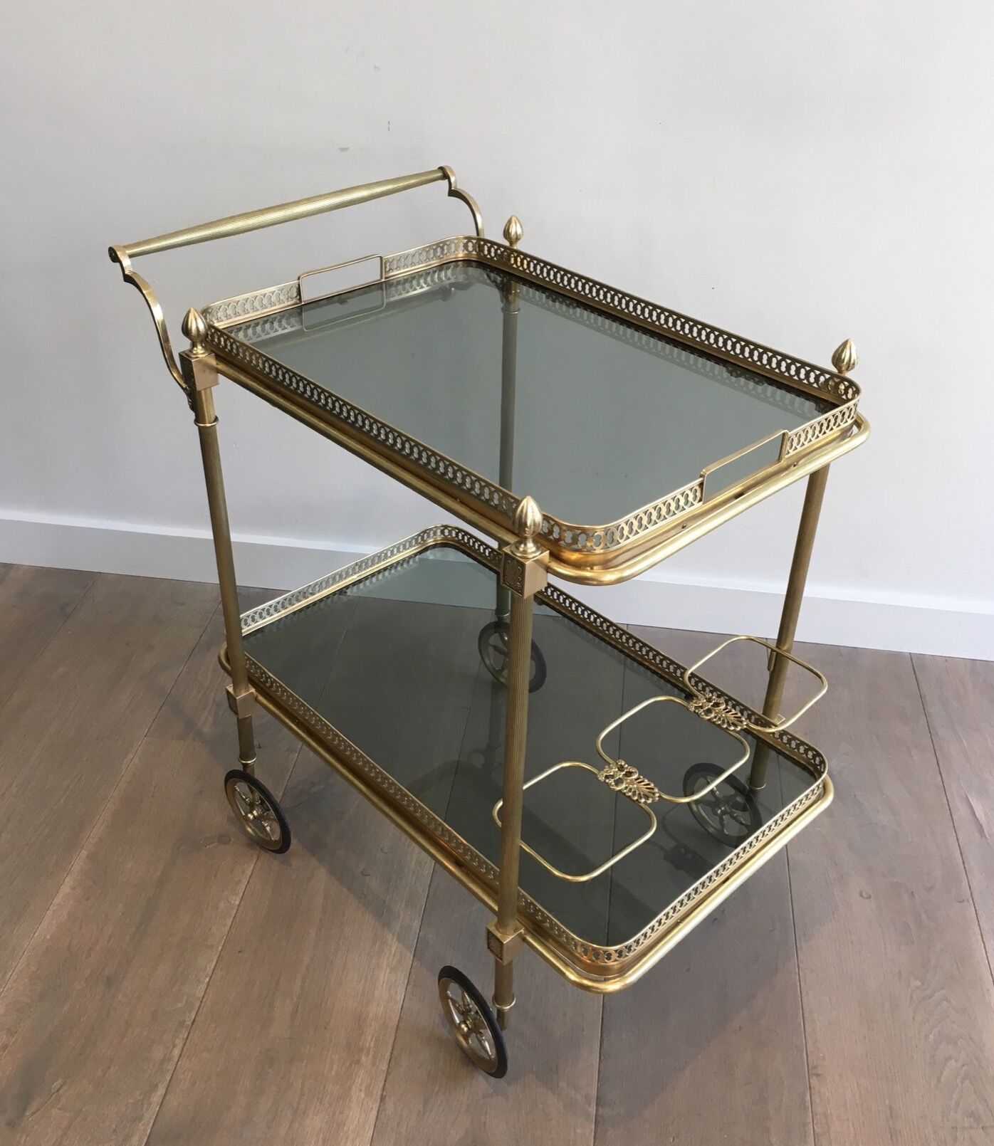 Neoclassical style rolling table in brass with blue glass tops