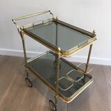 Neoclassical style rolling table in brass with blue glass tops