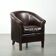 Dark cow leather club armchair with a stylish design in English style