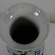 China. Porcelain mallet vase with blue and white phoenix decoration on a rock.
