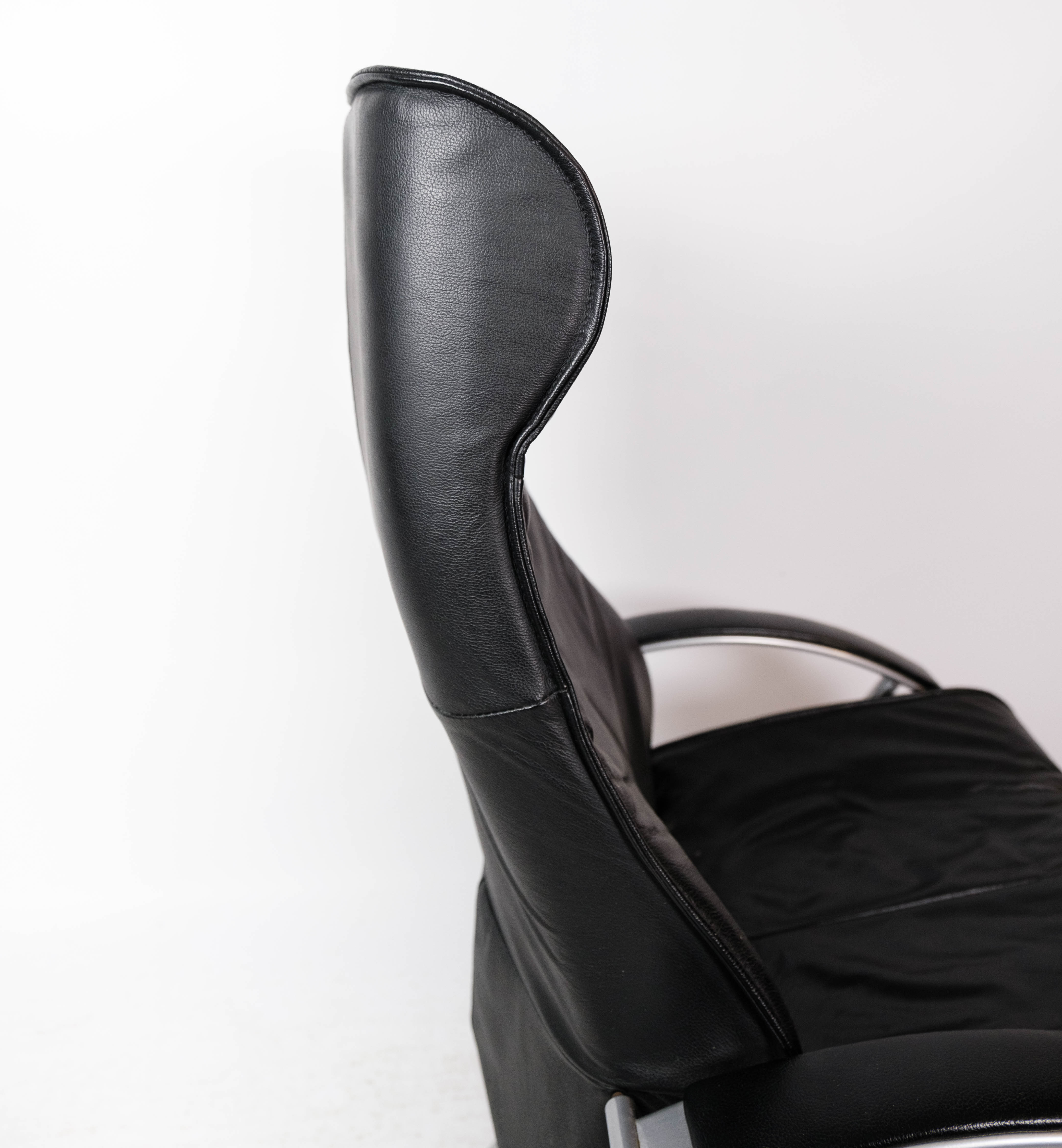 Easy chair with stool upholstered with black leather of Danish design, 1970s